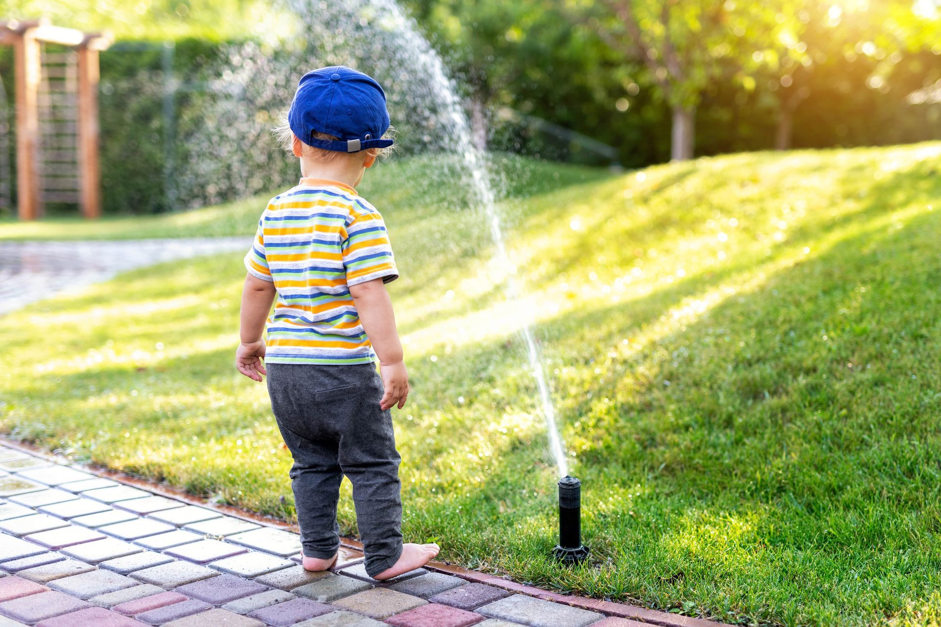 child admiring Fort Myers irrigation craftsmanship