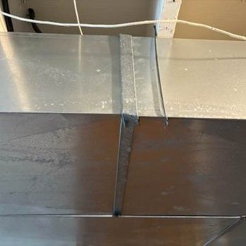 Metal ductwork, with a seam taped.