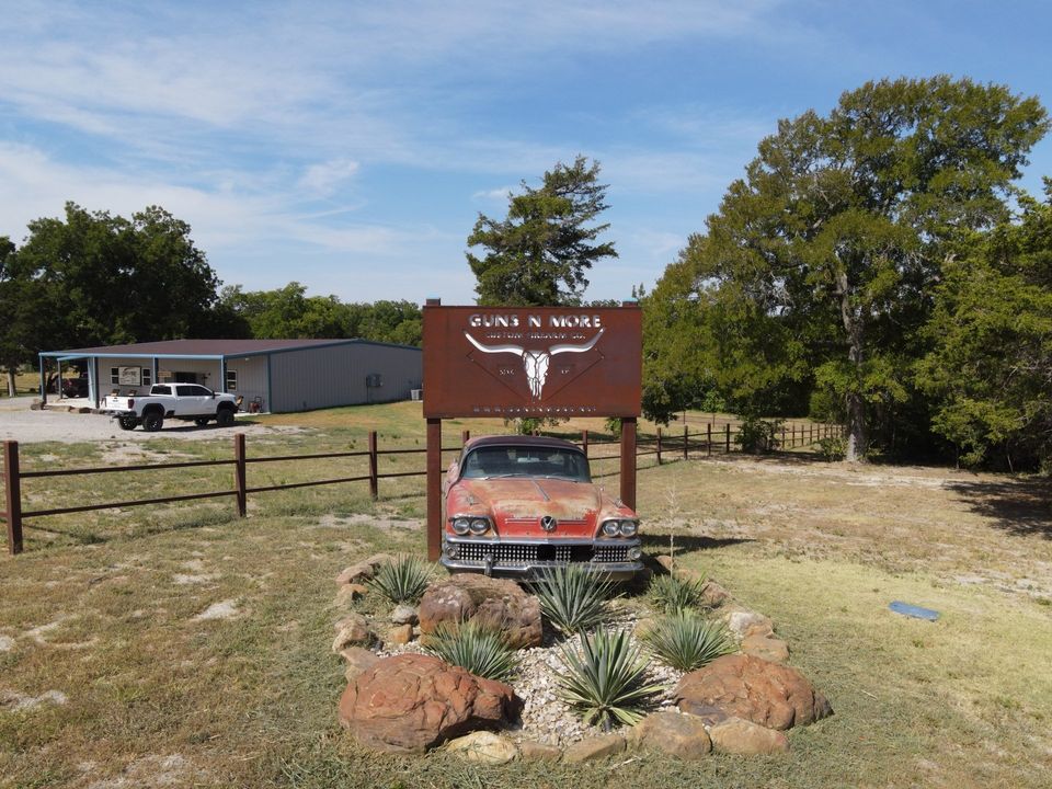 A car is parked in front of a sign that says ' texas ' on it