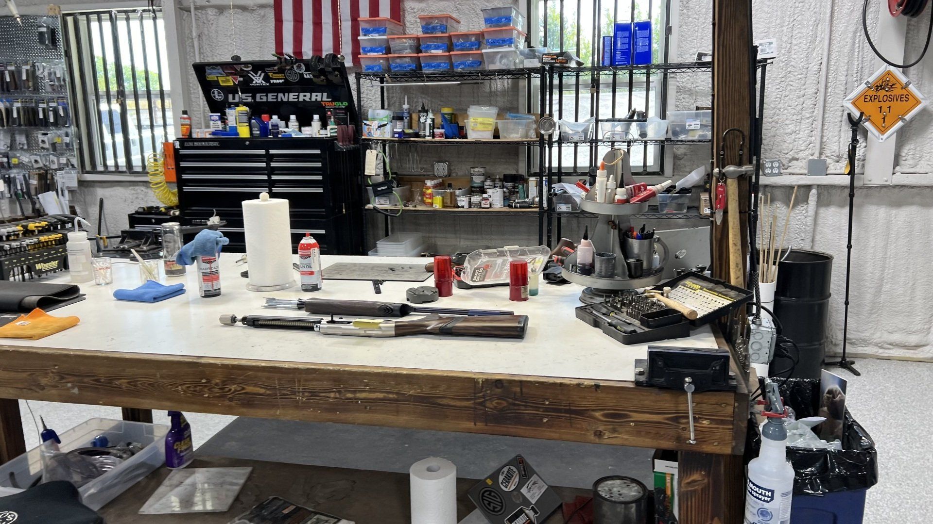 A workbench in a garage filled with tools and supplies.