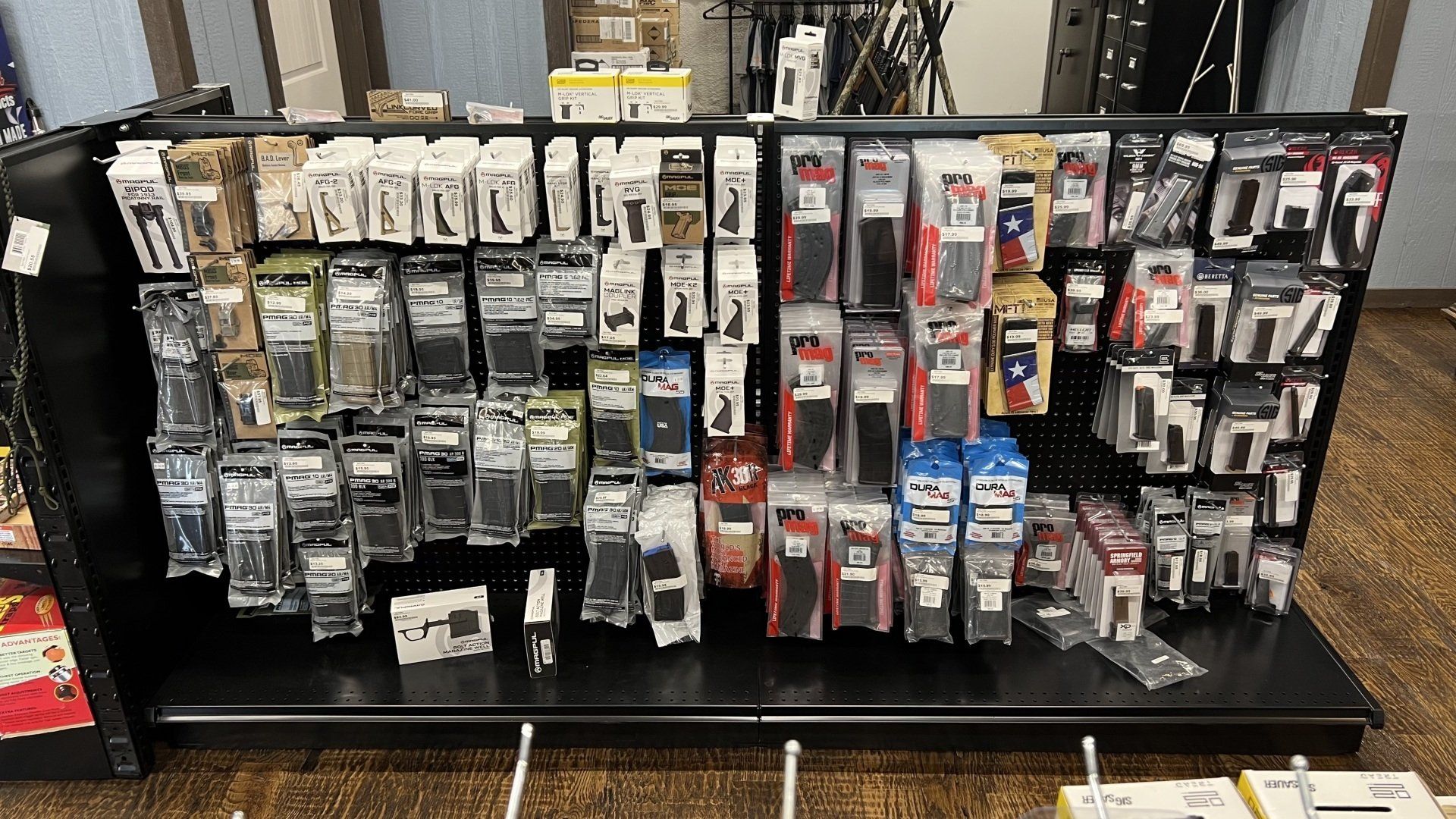 A store shelf filled with lots of different types of batteries.