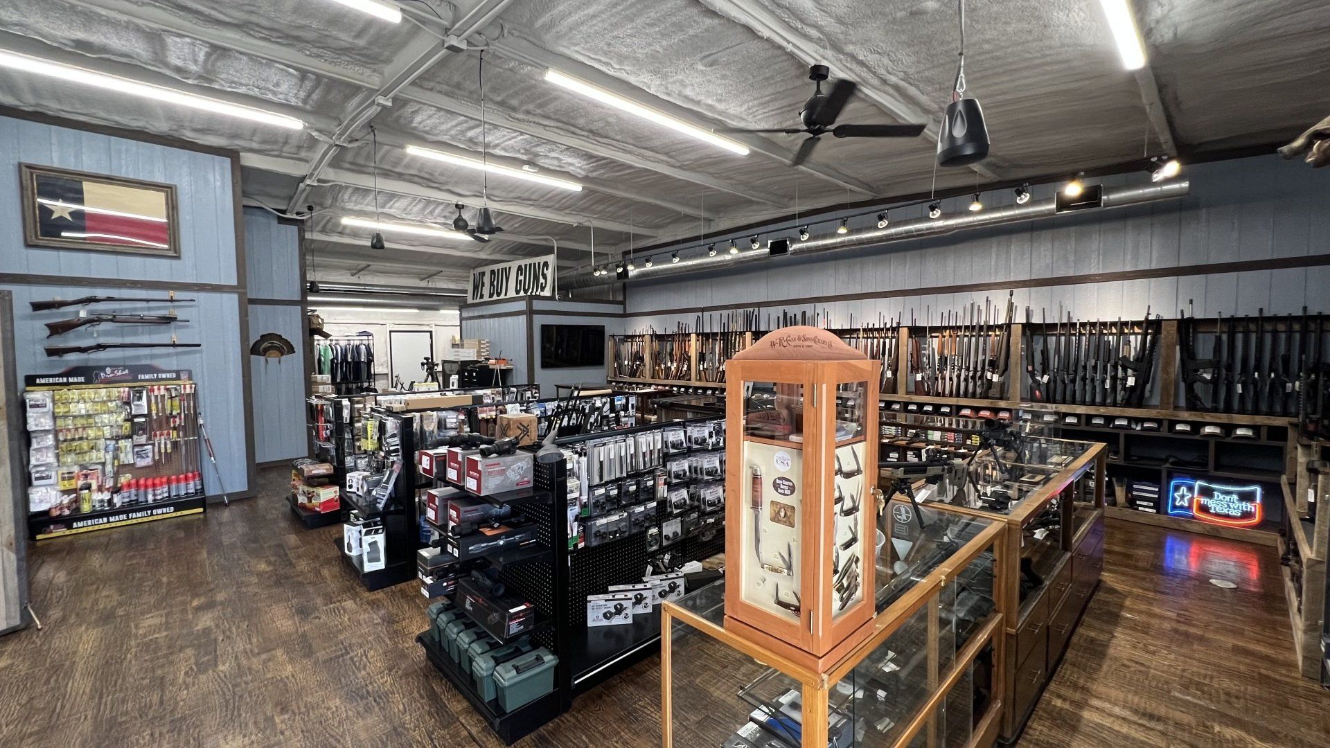 A large room filled with lots of shelves and a ceiling fan.