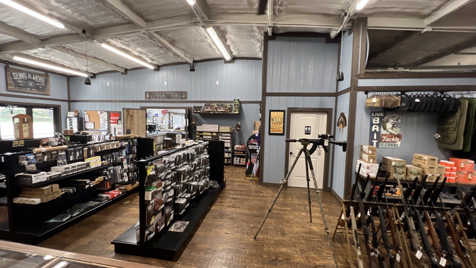 A store filled with lots of shelves and a telescope on a tripod.