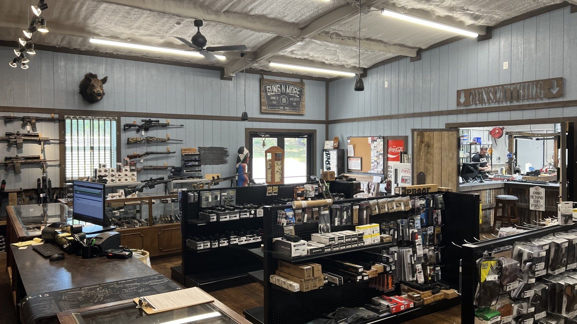 A large room filled with lots of shelves and a desk.