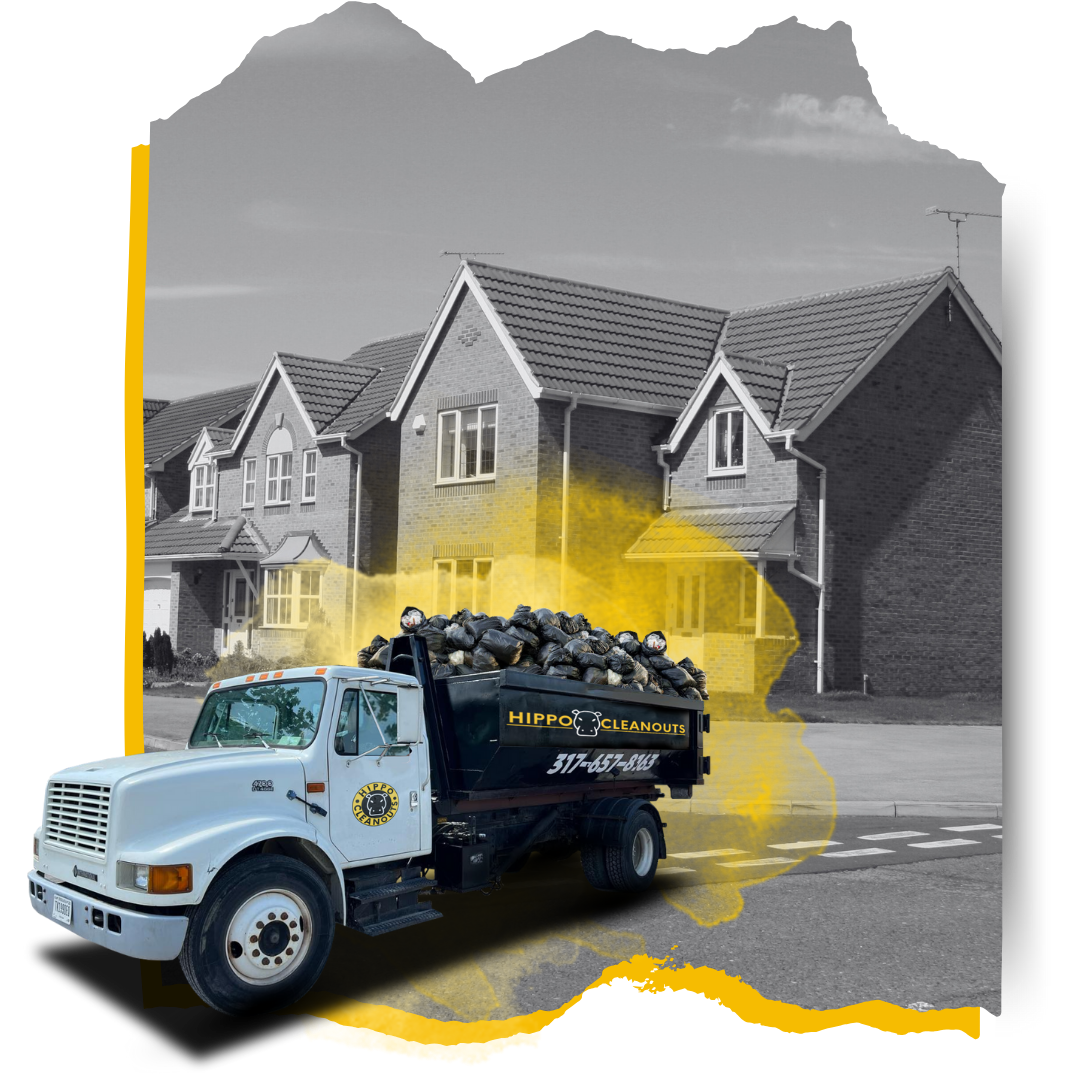 A Hippo dumpster truck loaded with garbage in front of a house.