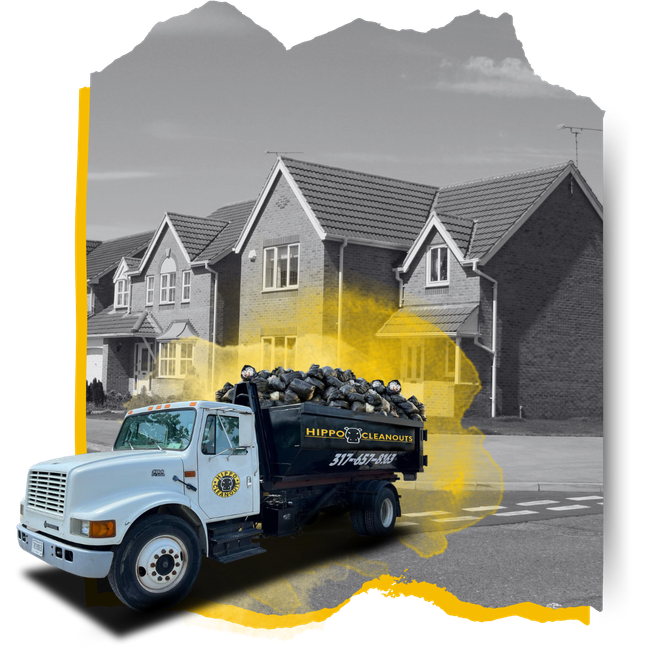 A Hippo dumpster truck loaded with garbage in front of a house.