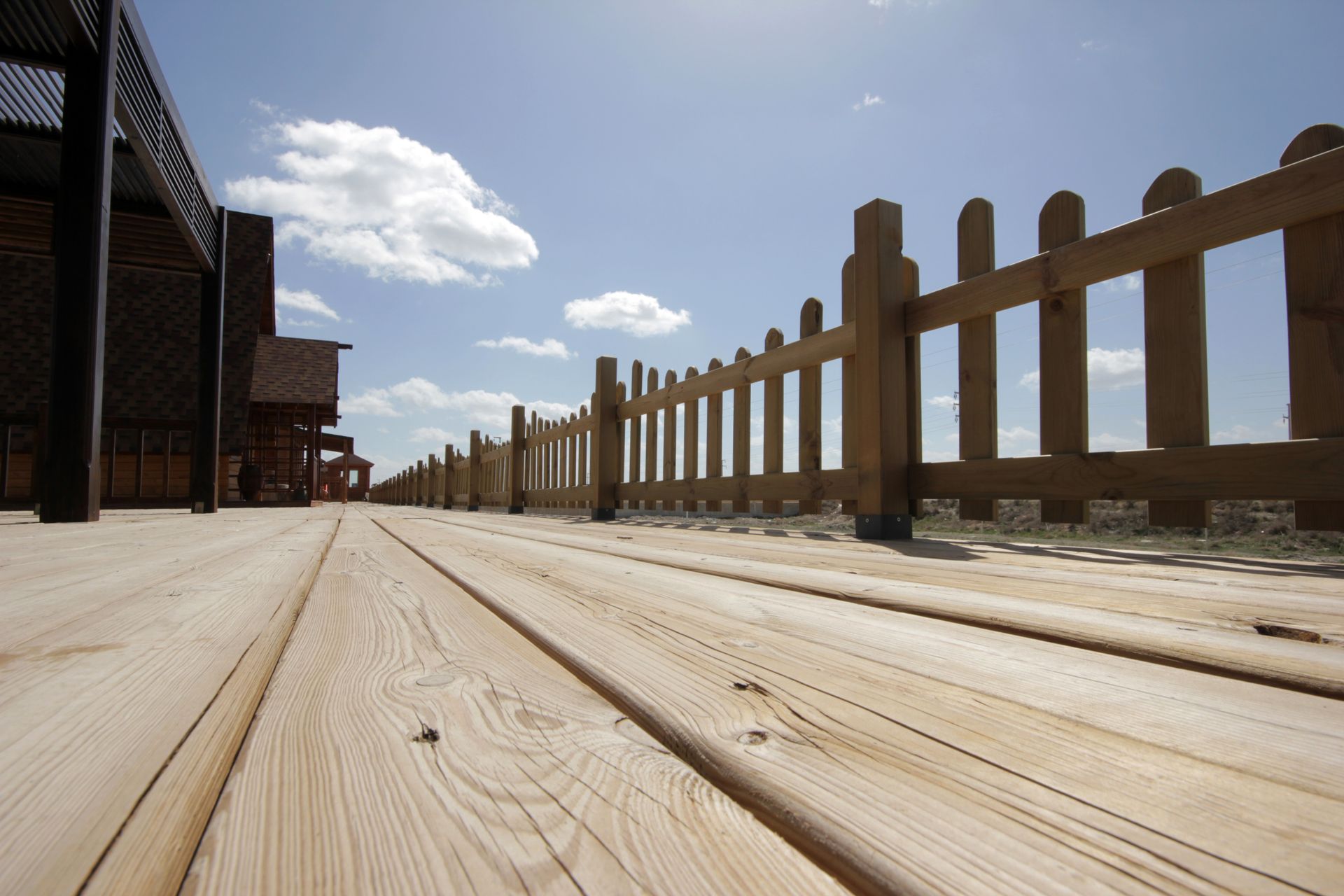 A wooden deck with a wooden fence in the background