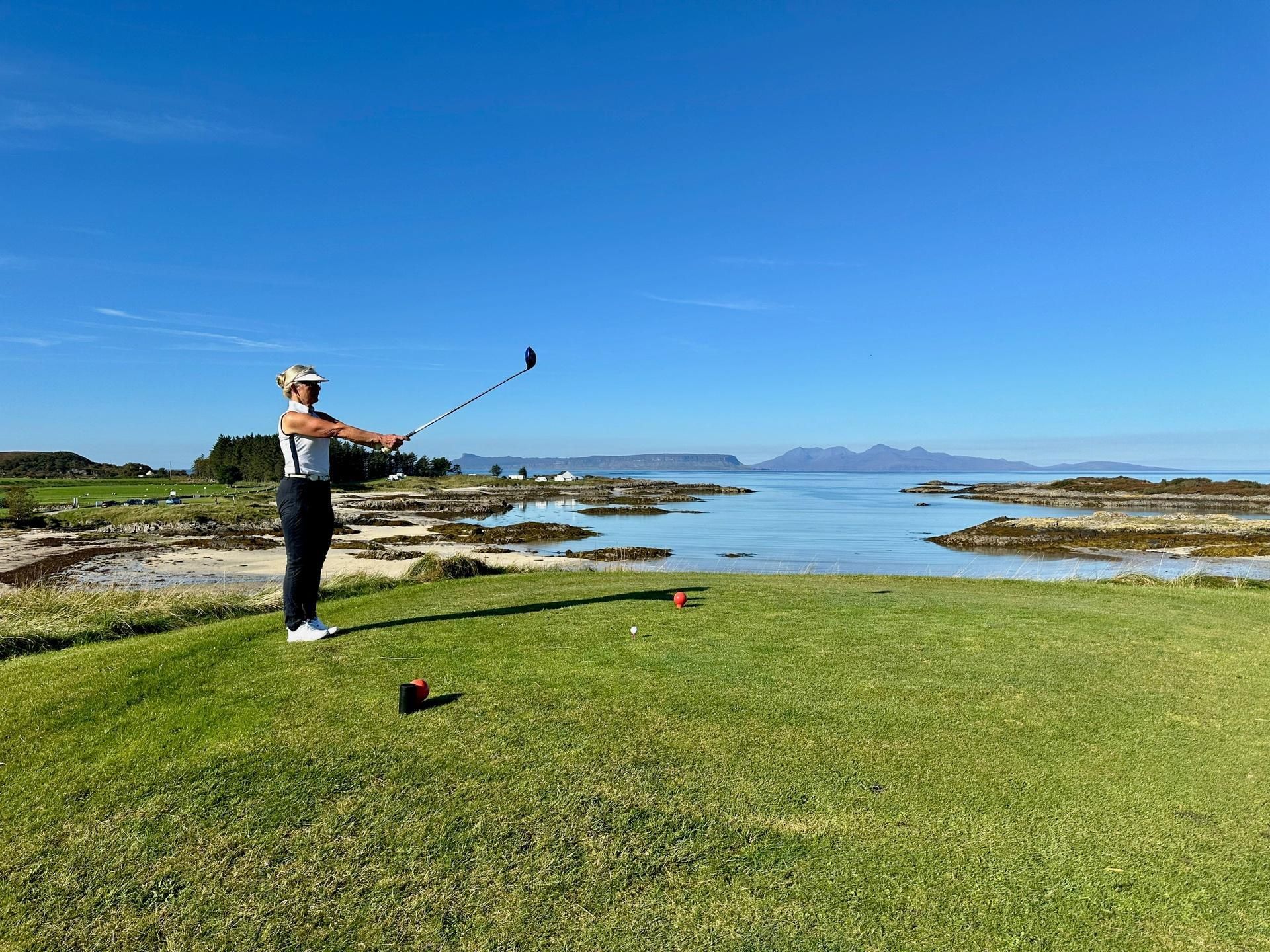 lady golfer getting ready to hit tee shot  in scandinavia