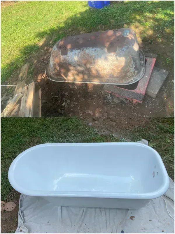 A bathtub is sitting in the grass next to a hole in the ground.