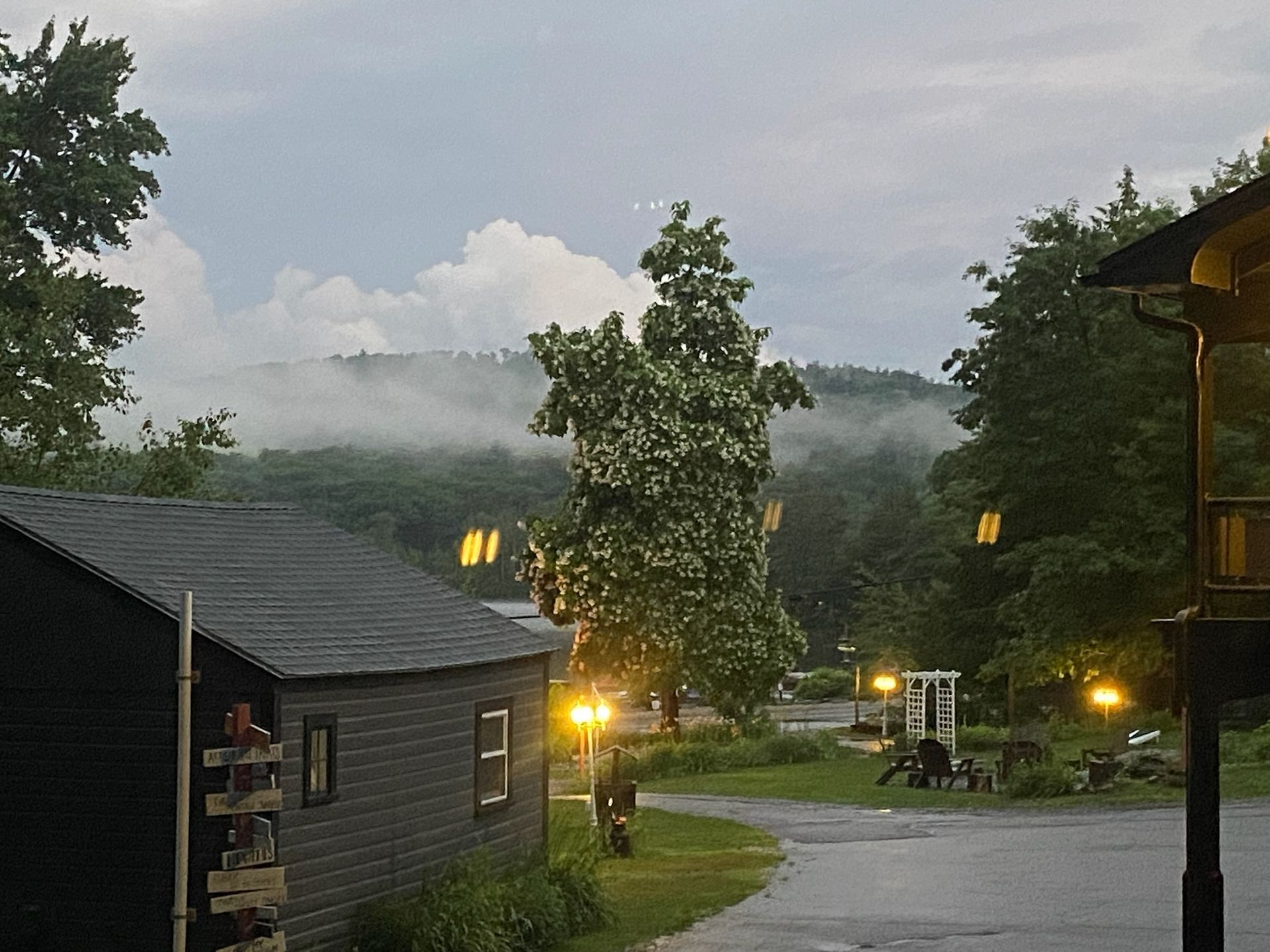 A view of a house with a foggy hill in the background