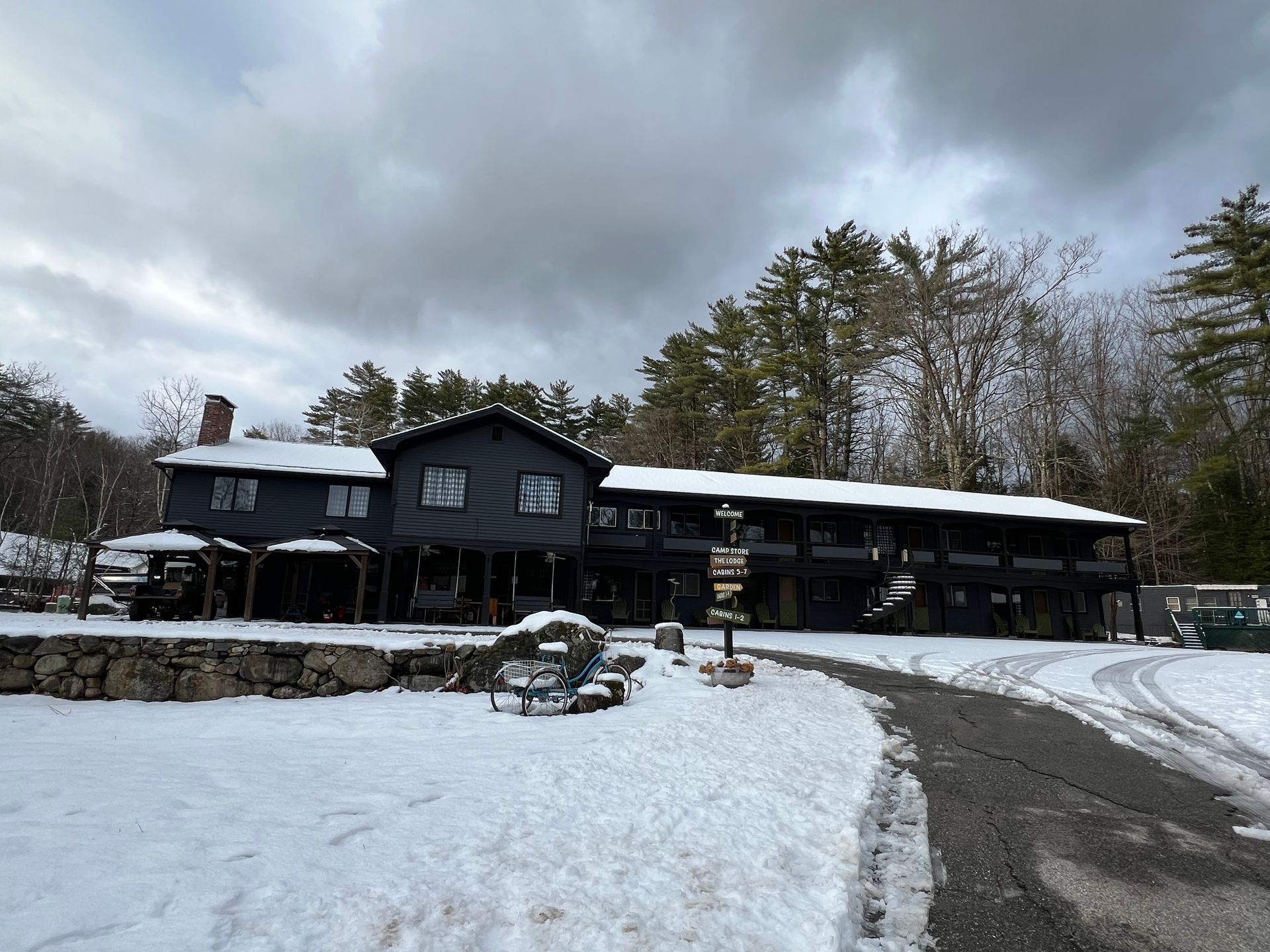A large house is covered in snow on a cloudy day.