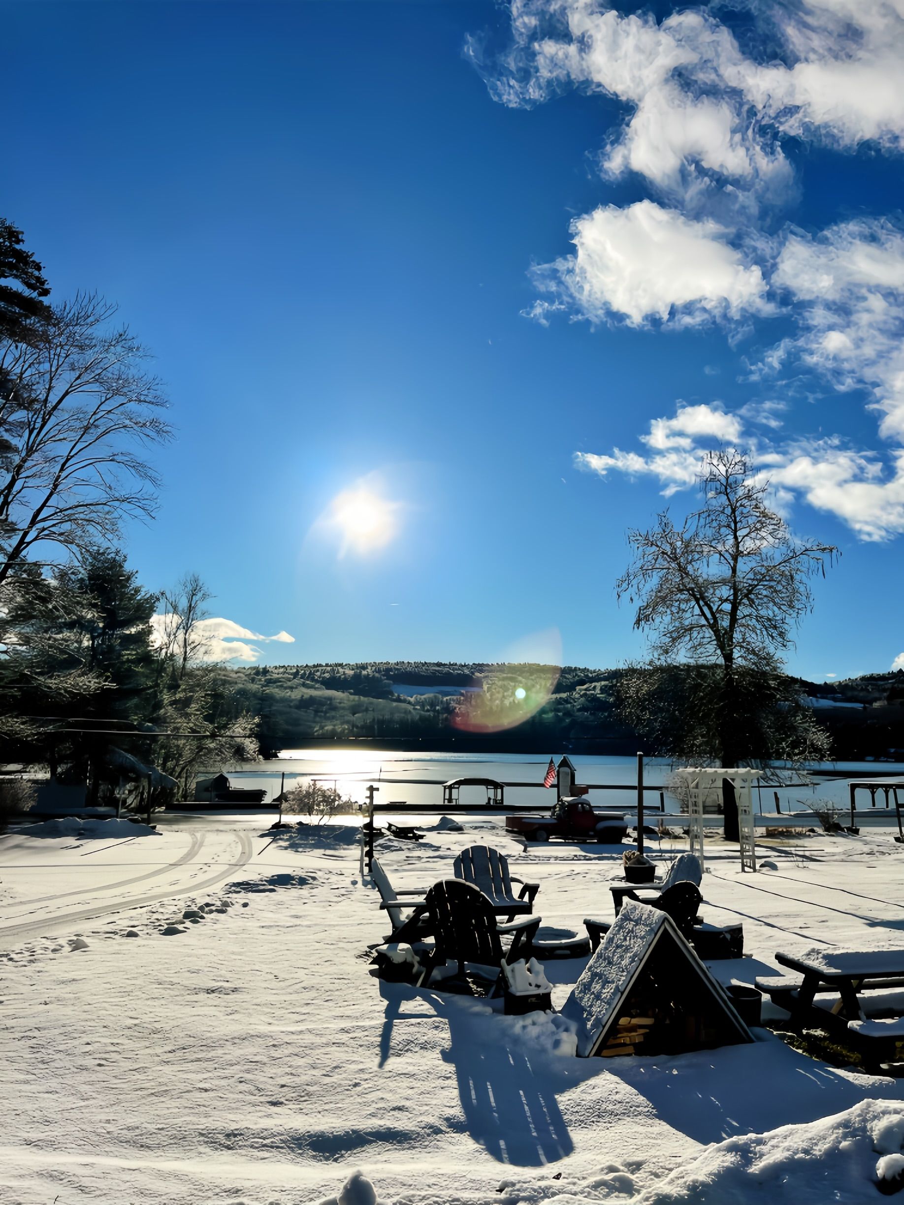 A snowy area with a lake in the background