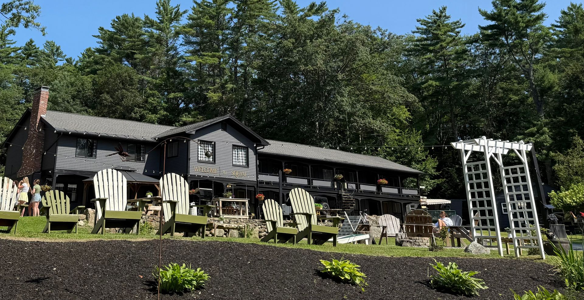 A view of a picnic area with a lake in the background