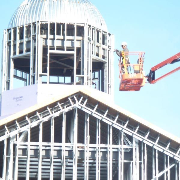 Construction Worker Using Lifting Boom Machinery — Kings Mountain, NC — Coleman Contractors Inc