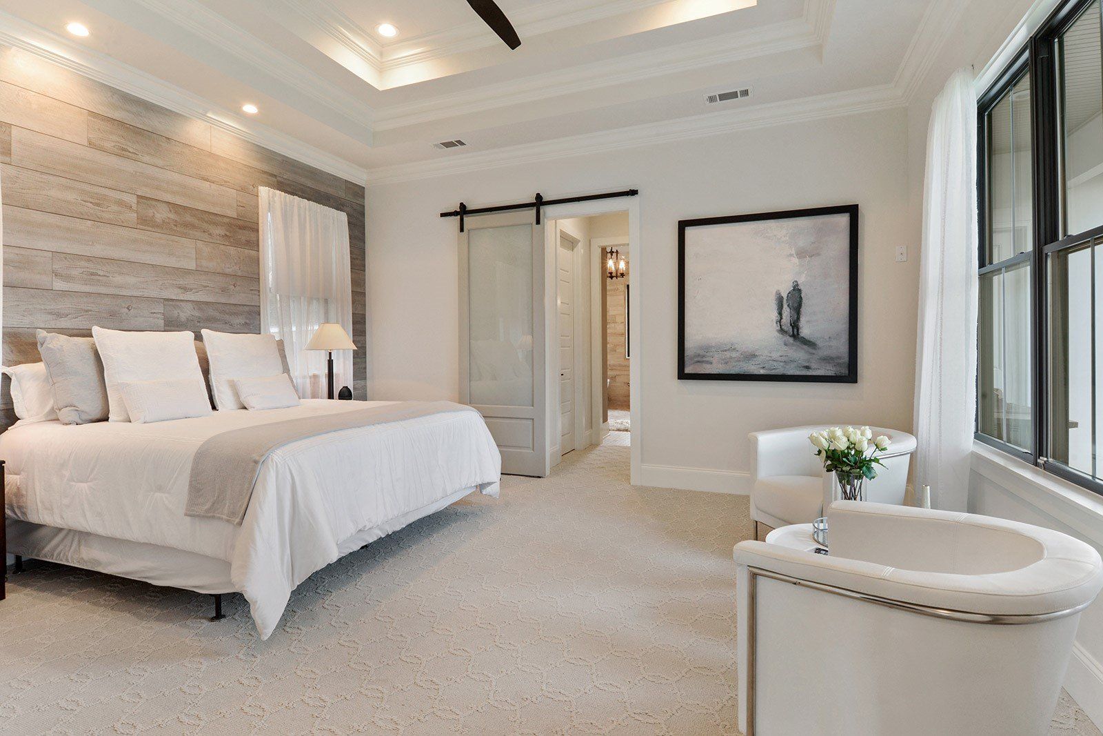 master bedroom with white chairs