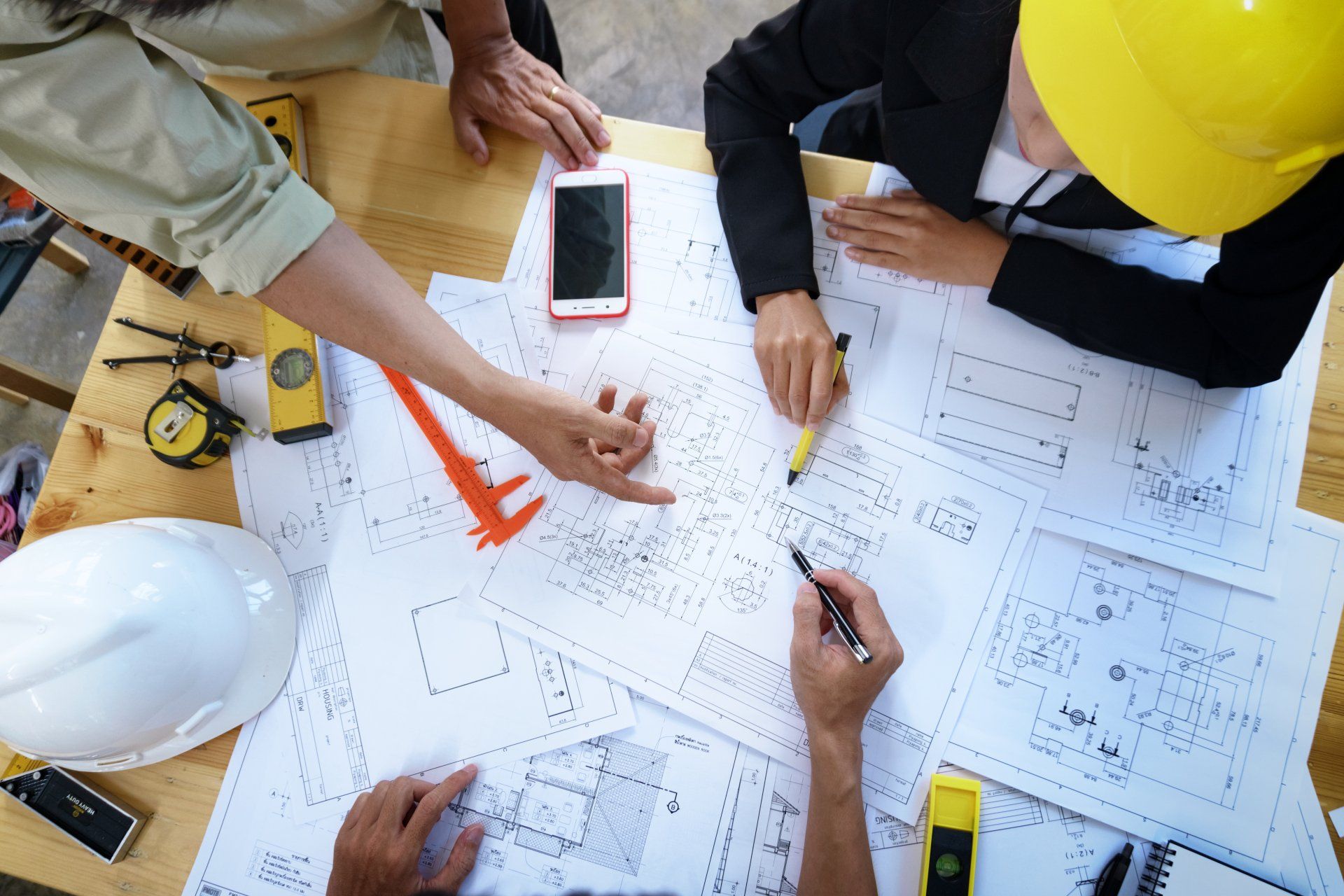 engineer people meeting working and pointing at a drawings in office for discussing. Engineering tools and construction concept.