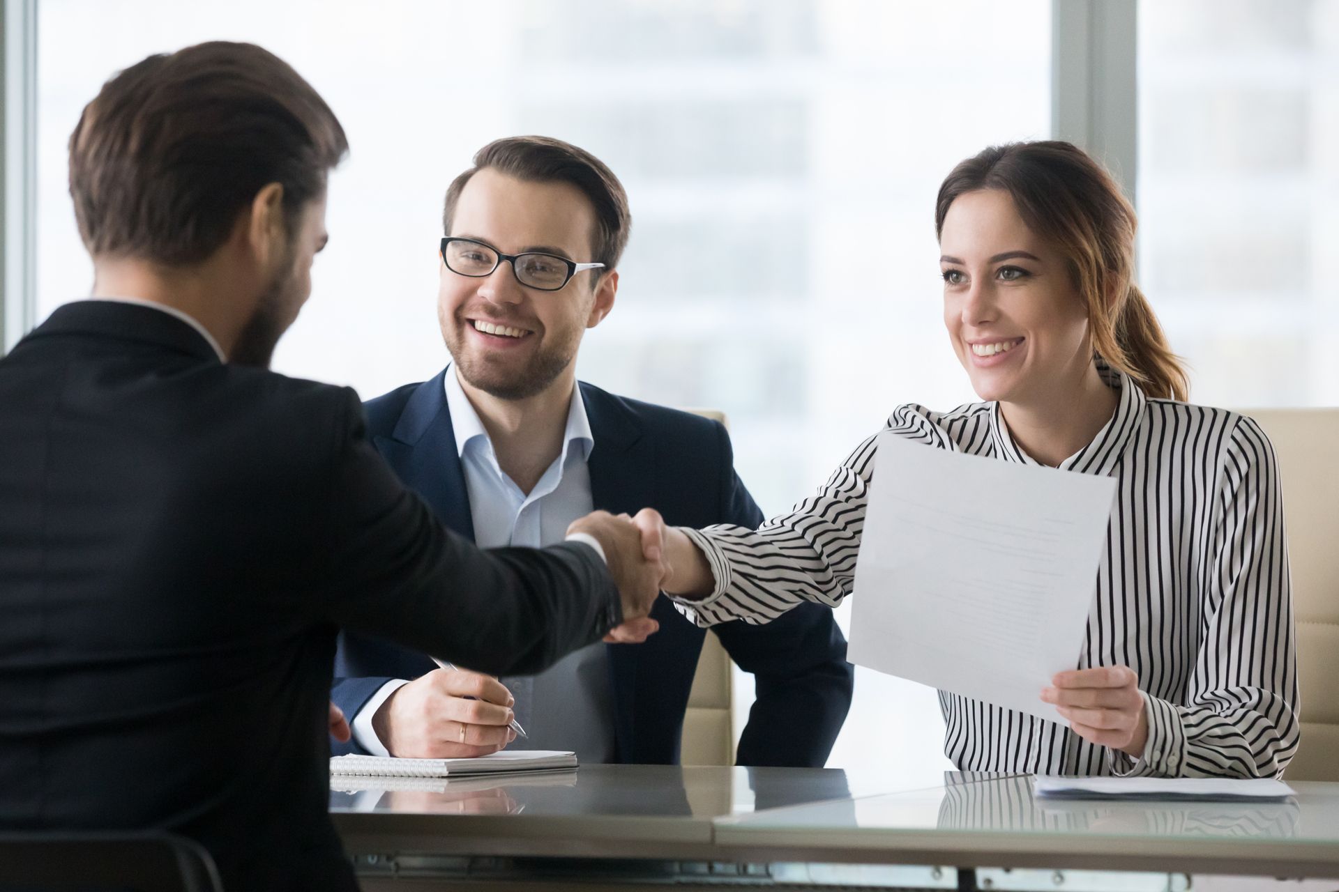 A Man and a Woman Are Shaking Hands During a Job Interview