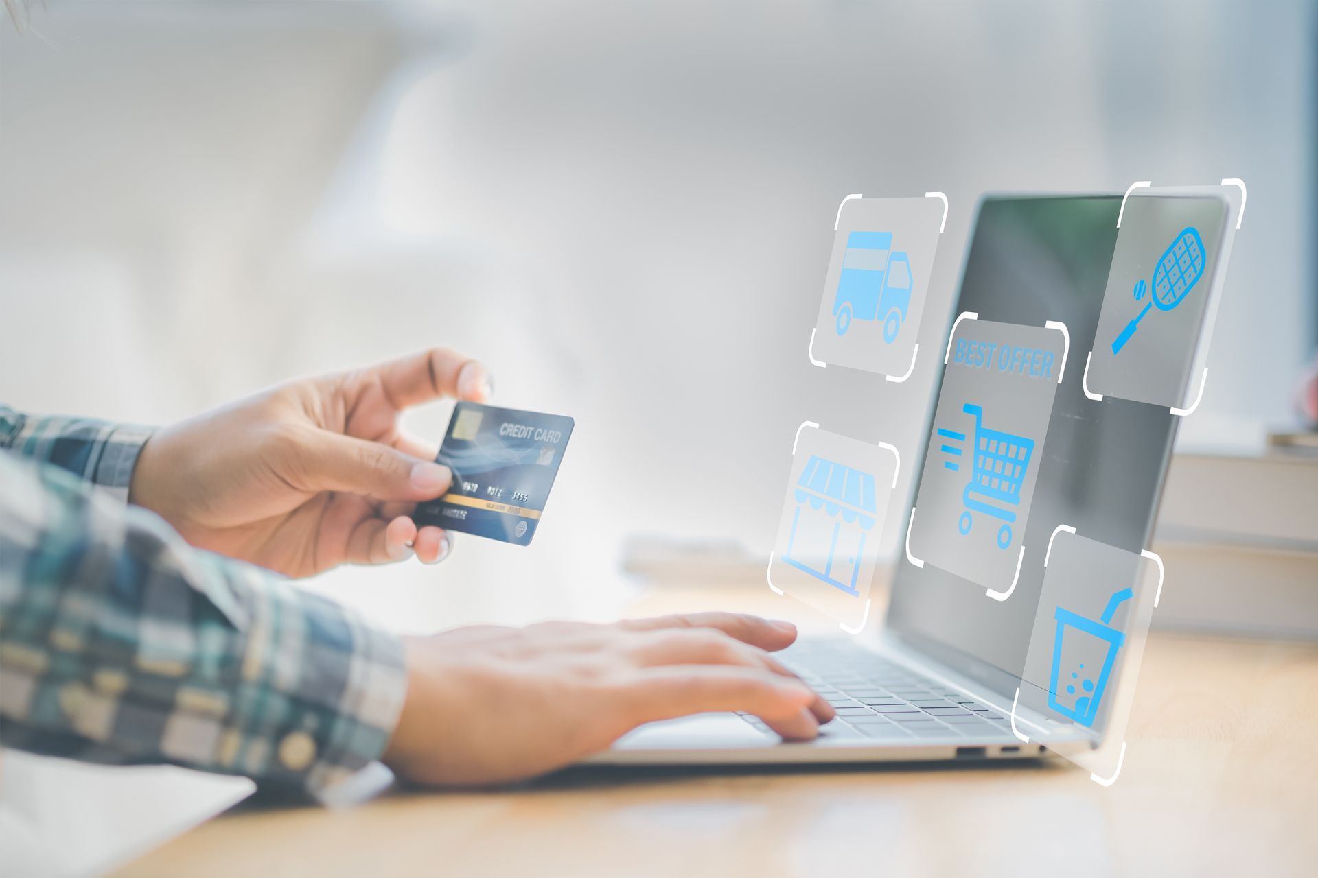 A Person is Holding a Credit Card in Front of a Laptop Computer