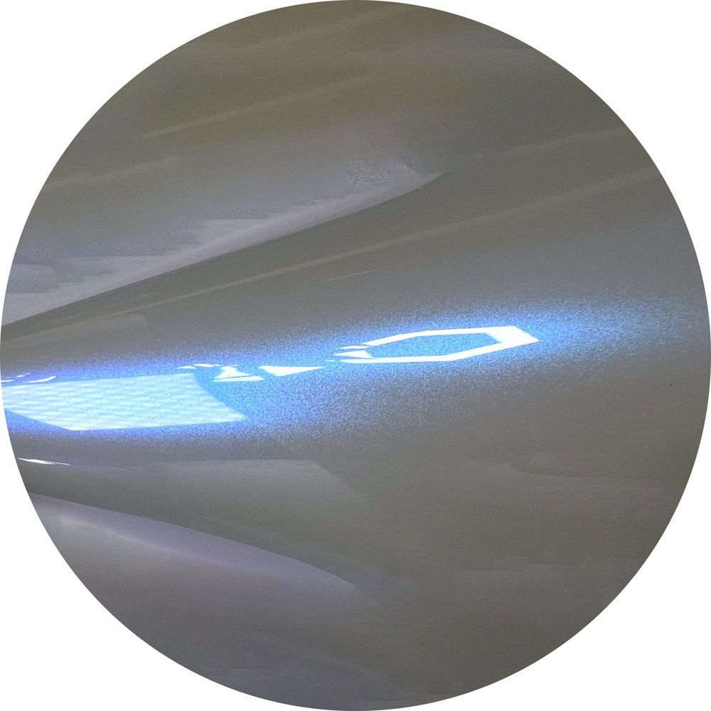 A close up of a circle with a blue light shining through it