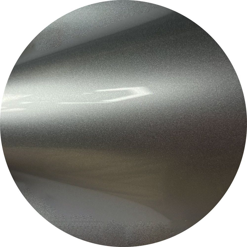 A close up of a silver circle with a white background