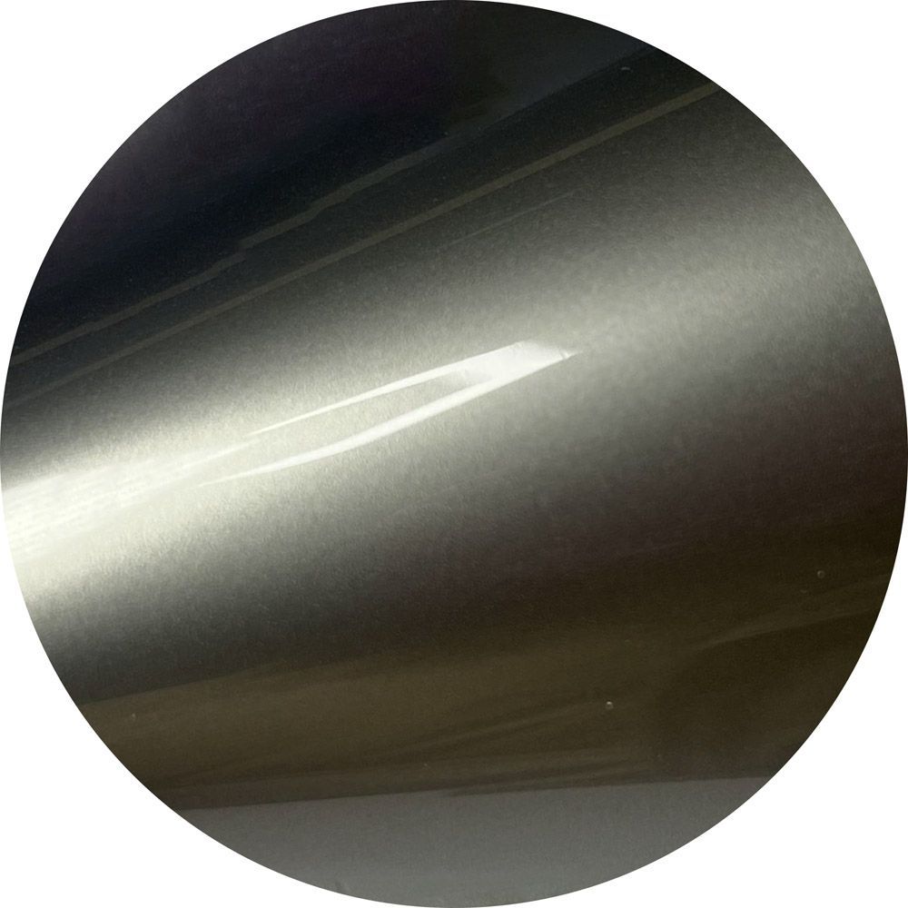 A close up of a metal surface in a circle