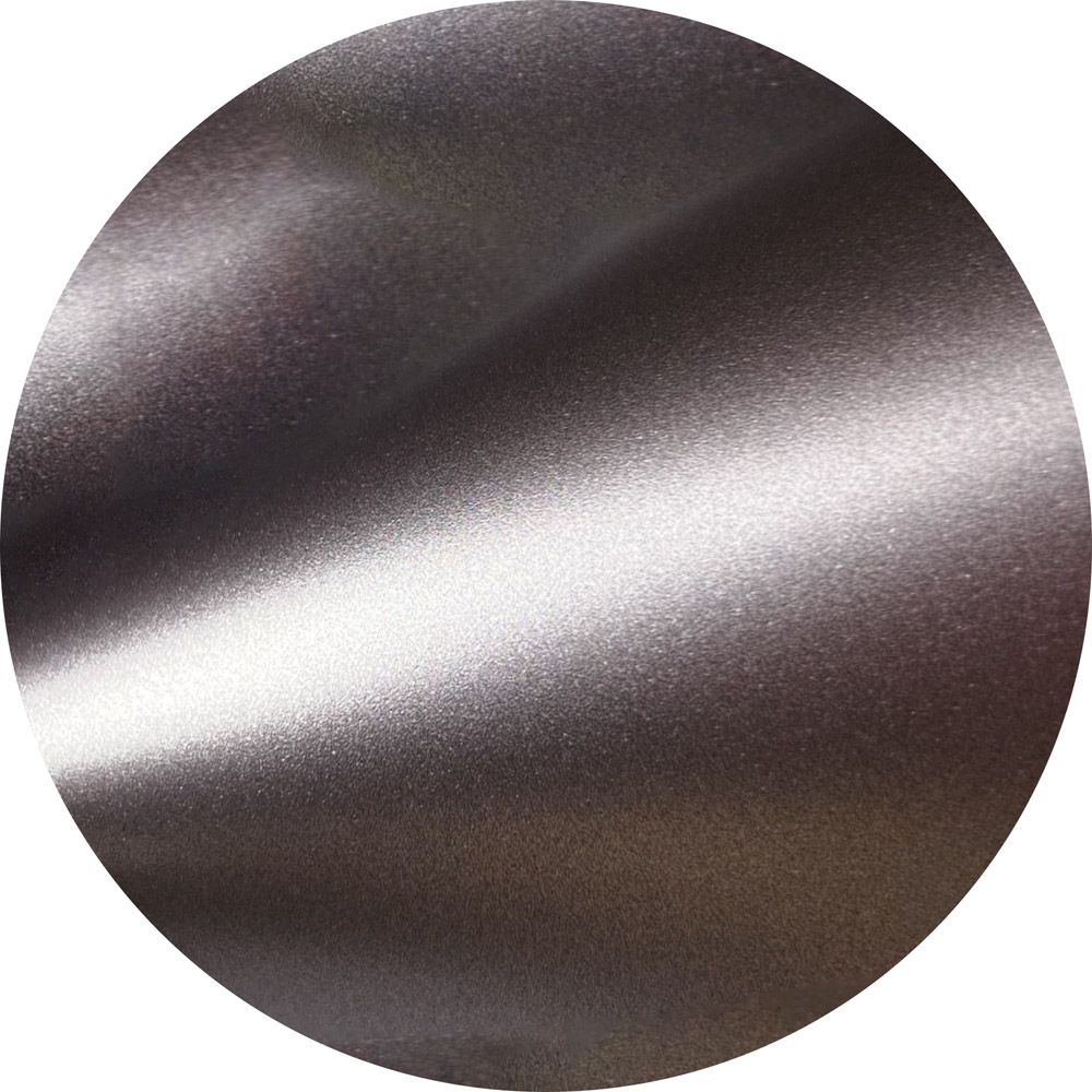 A close up of a metal circle with a white background