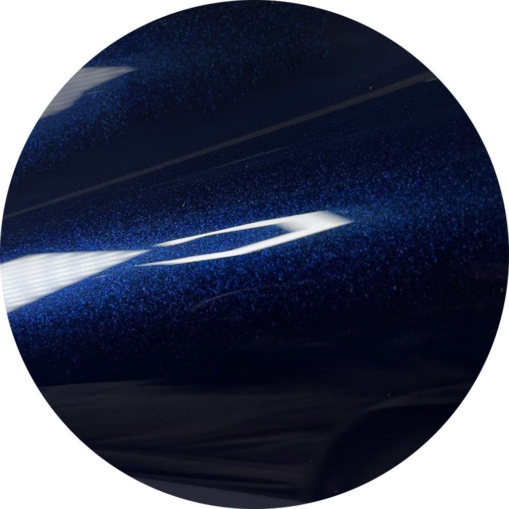 A close up of a dark blue circle with sparkles on it