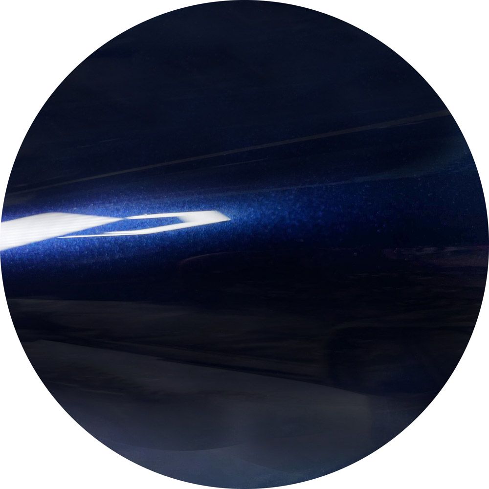 A dark blue circle with a light shining through it