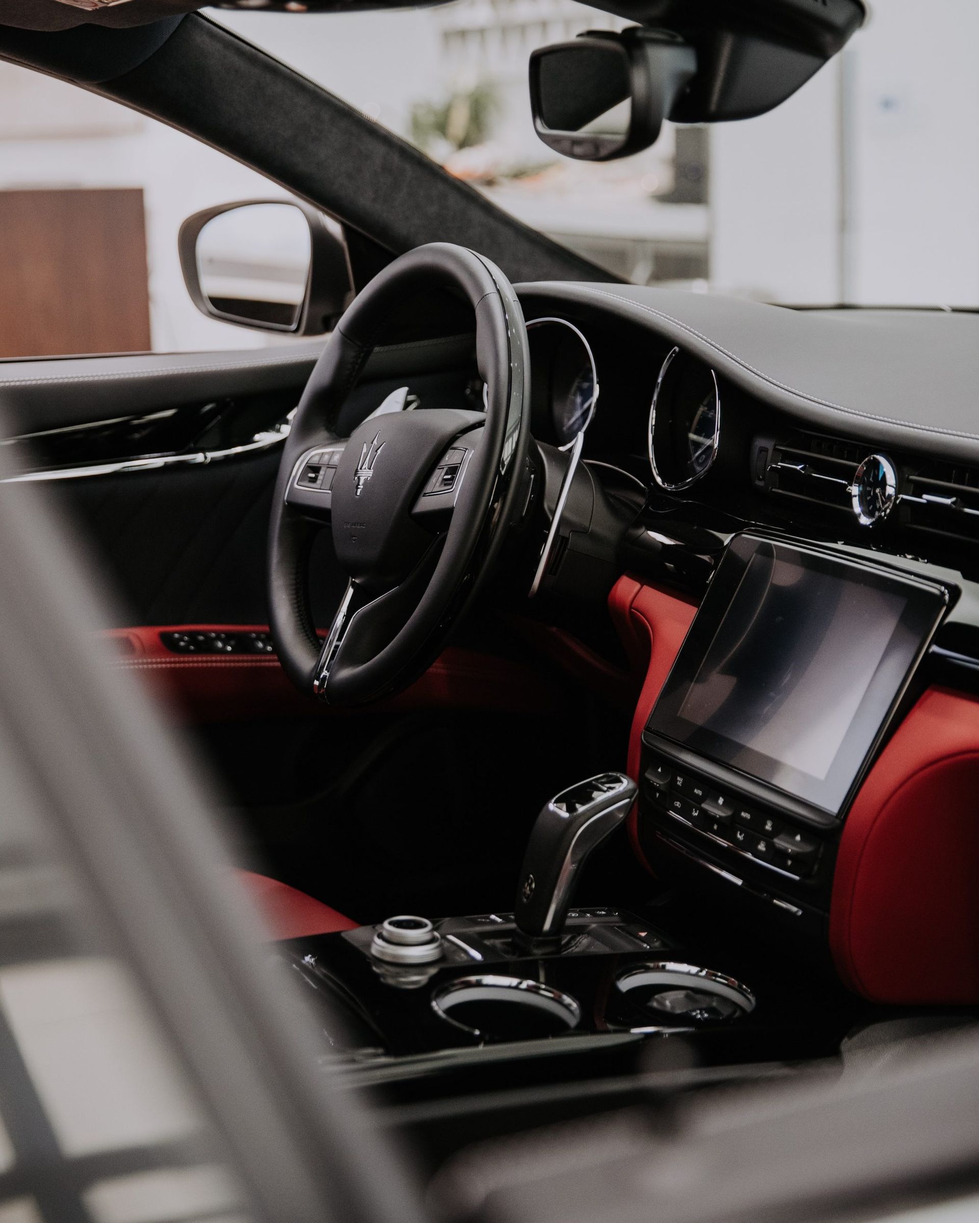 The inside of a car with a steering wheel and dashboard