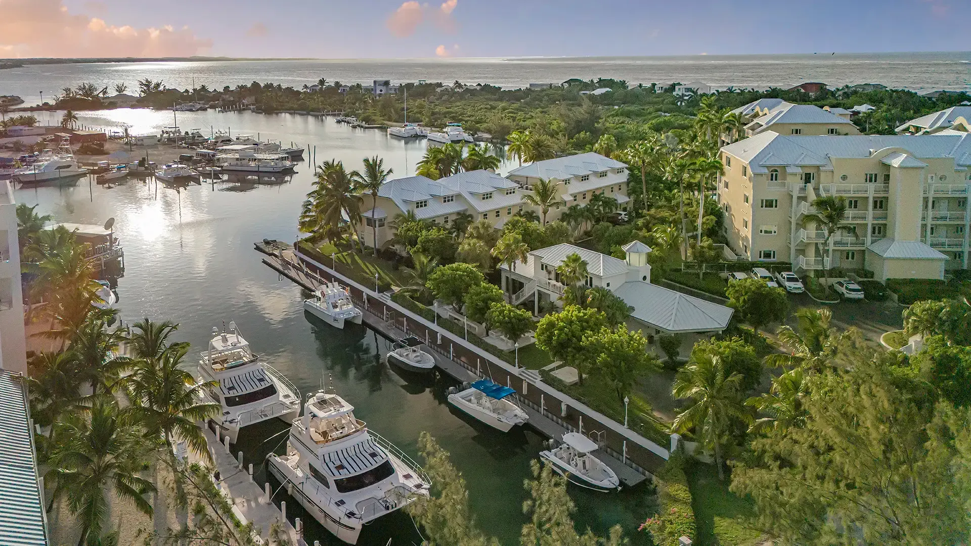 An aerial view of a marina with boats docked and buildings in the background.