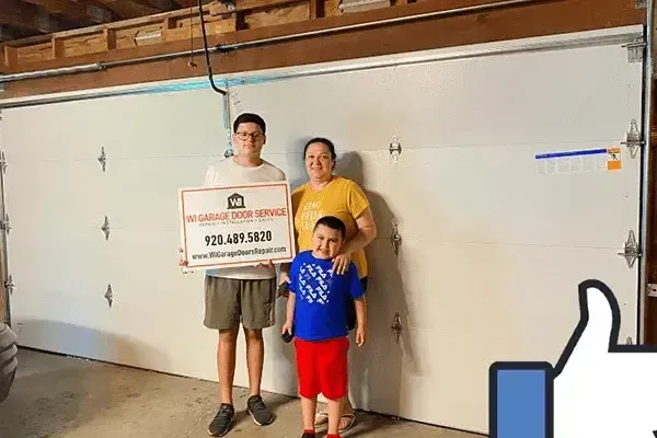 Three people stand in front of a white garage door holding a business sign with the phone number 920-489-5870.