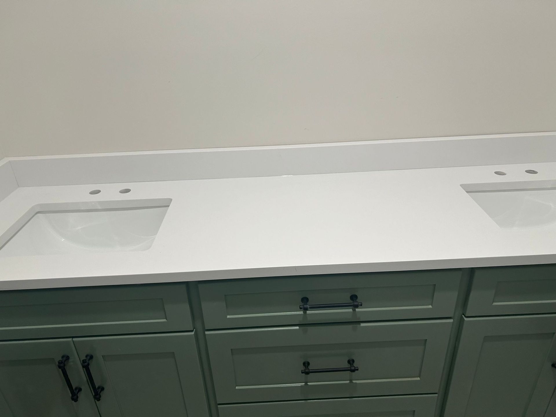 Light blue bathroom vanity with a white countertop and two sinks.