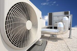 A close up of a fan on top of a building