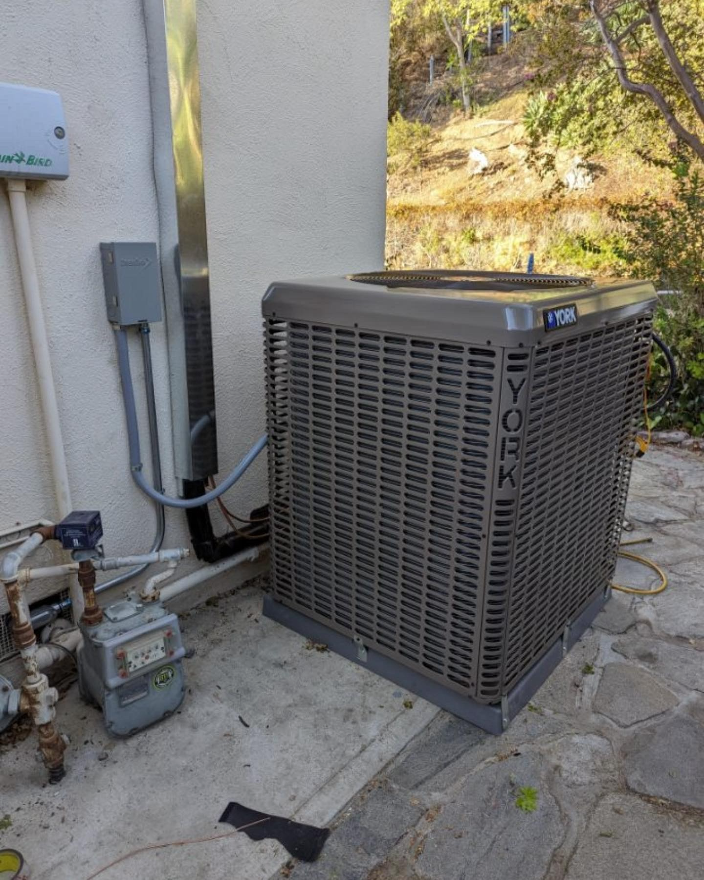 A york air conditioner is sitting outside of a building