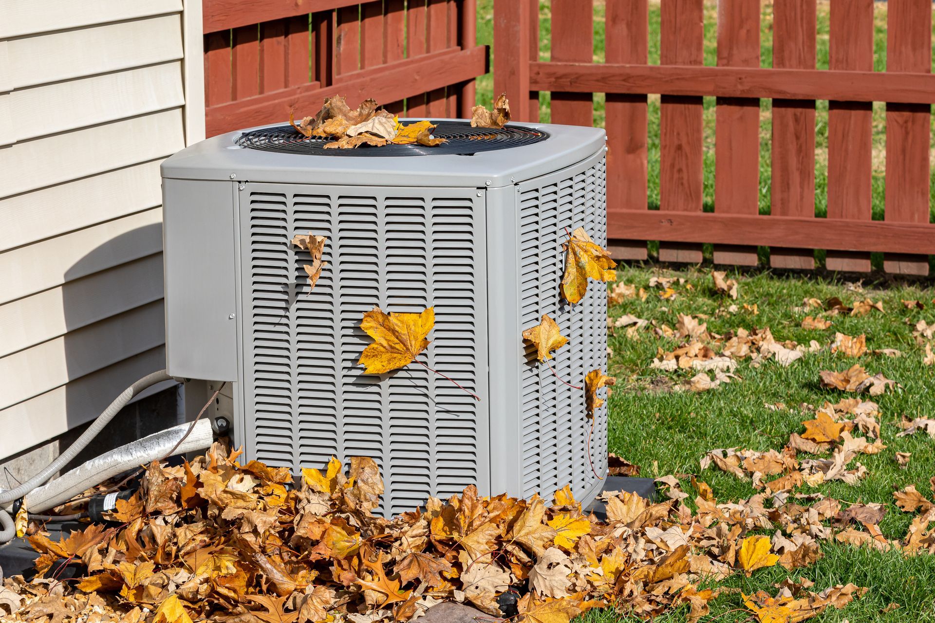 Dirty air conditioning unit covered in leaves during autumn. Home air conditioning, HVAC, repair, se