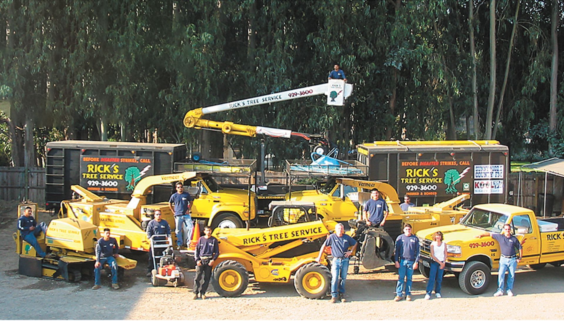 A group of men are posing for a picture in front of a truck.