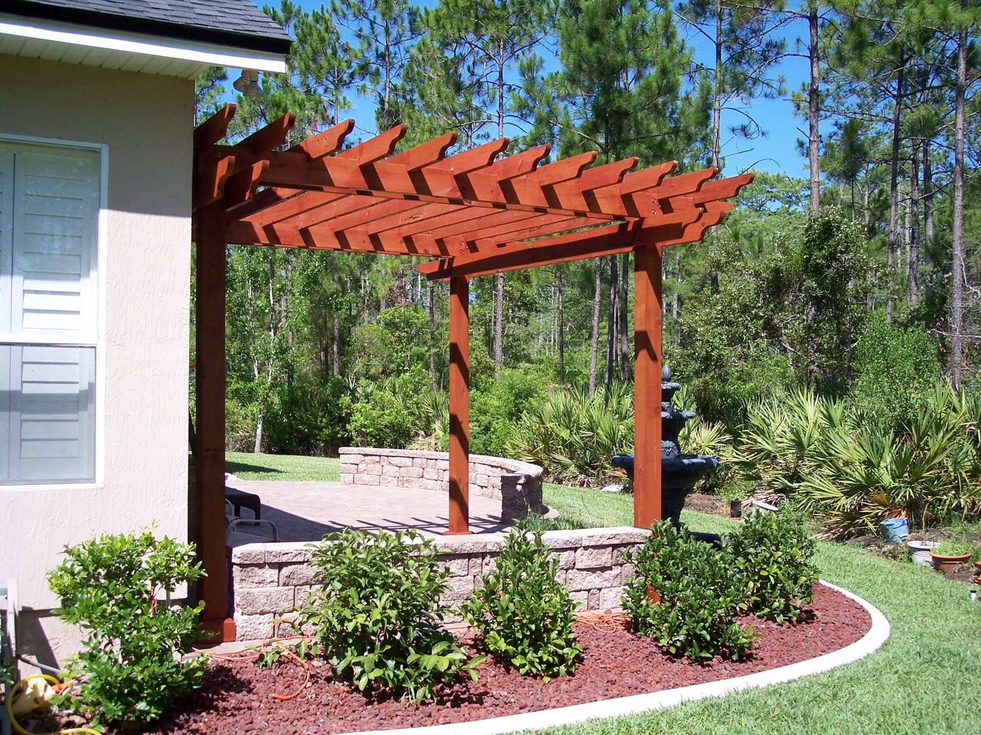 paver patio, patio construction, Patio install, patio installation, pergola, sitting wall, stone wall, before and after, before & after, after picture, patio remodel