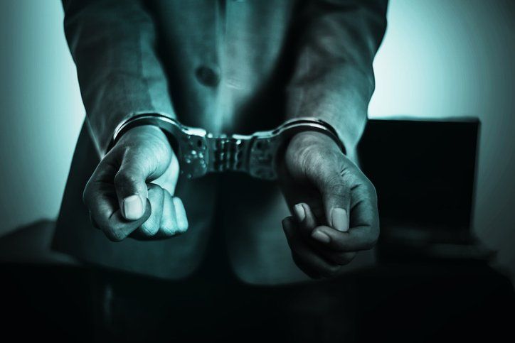 Business Man's hand in handcuff