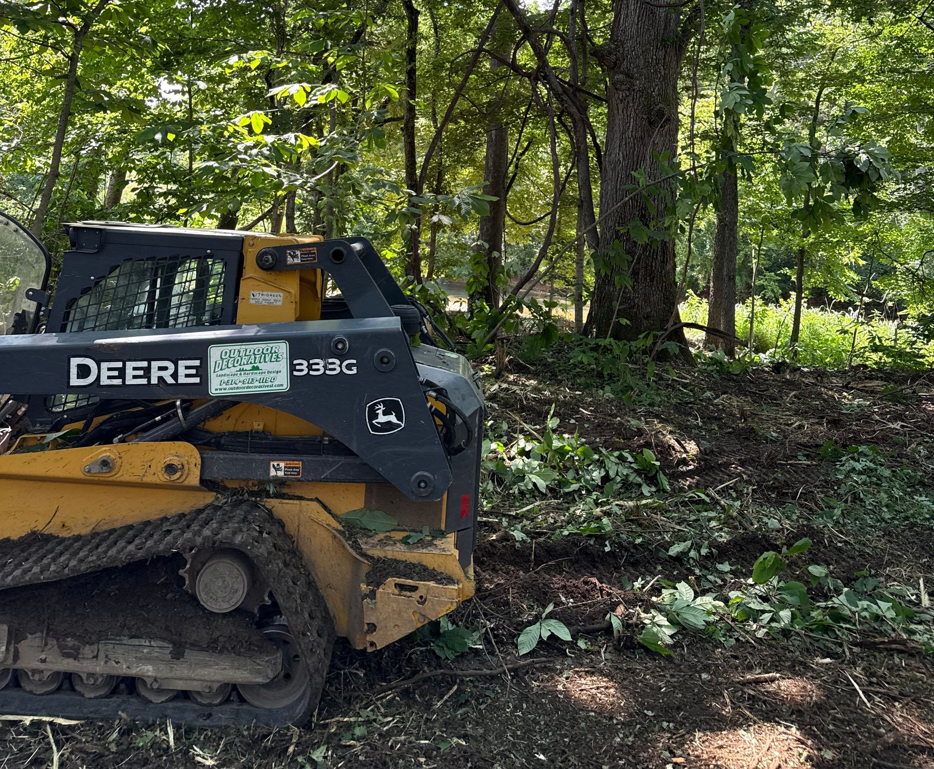 Pile of rubble from a building demolition with heavy machinery in the background.