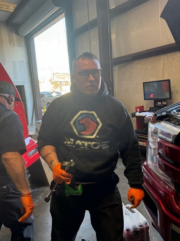Our Mechanic Holding a Car Part in DK Auto & Diesel Services Inc. in Magnolia, TX