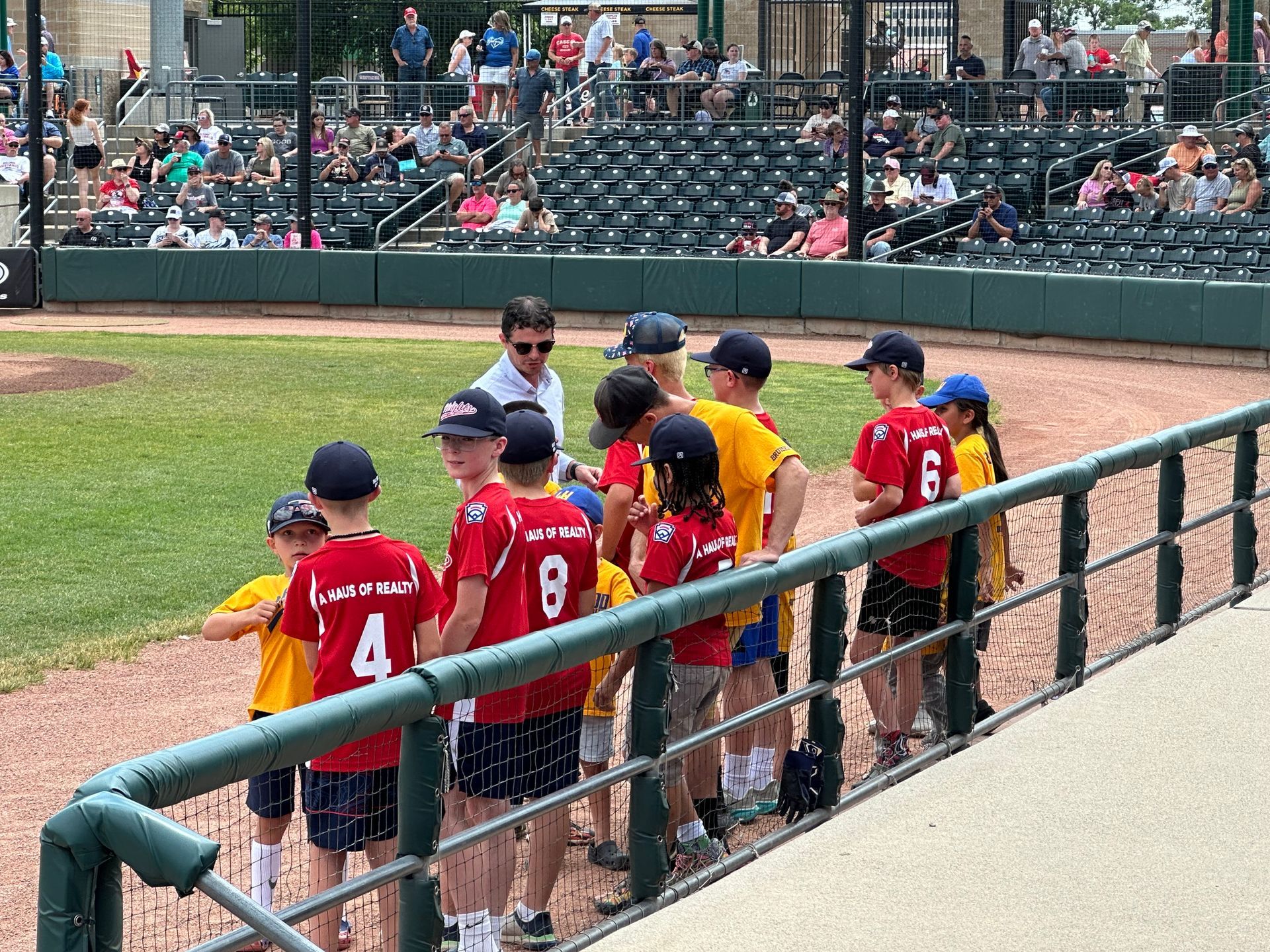 A Haus of Realty Heights National Little Leage Team on the Billings Mustangs' field at Dehler Park, Billings, MT