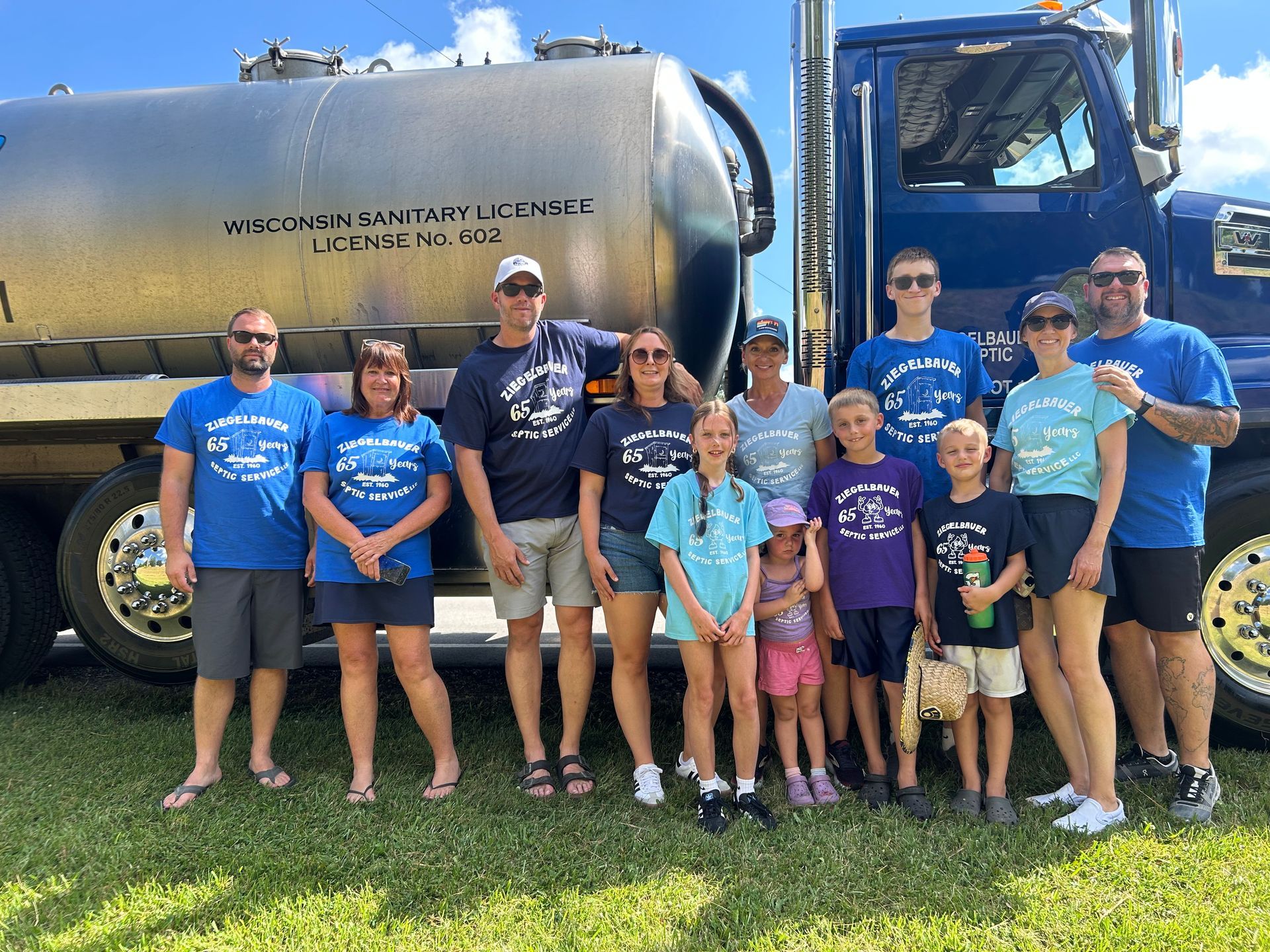 Septic Service Staff Beside their Blue Truck — Malone, WI — Ziegelbauer Septic Service LLC Septic Service Staff Beside their Blue Truck — Malone, WI — Ziegelbauer Septic Service LLC