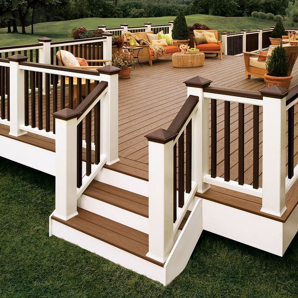 A wooden deck with a white railing and stairs