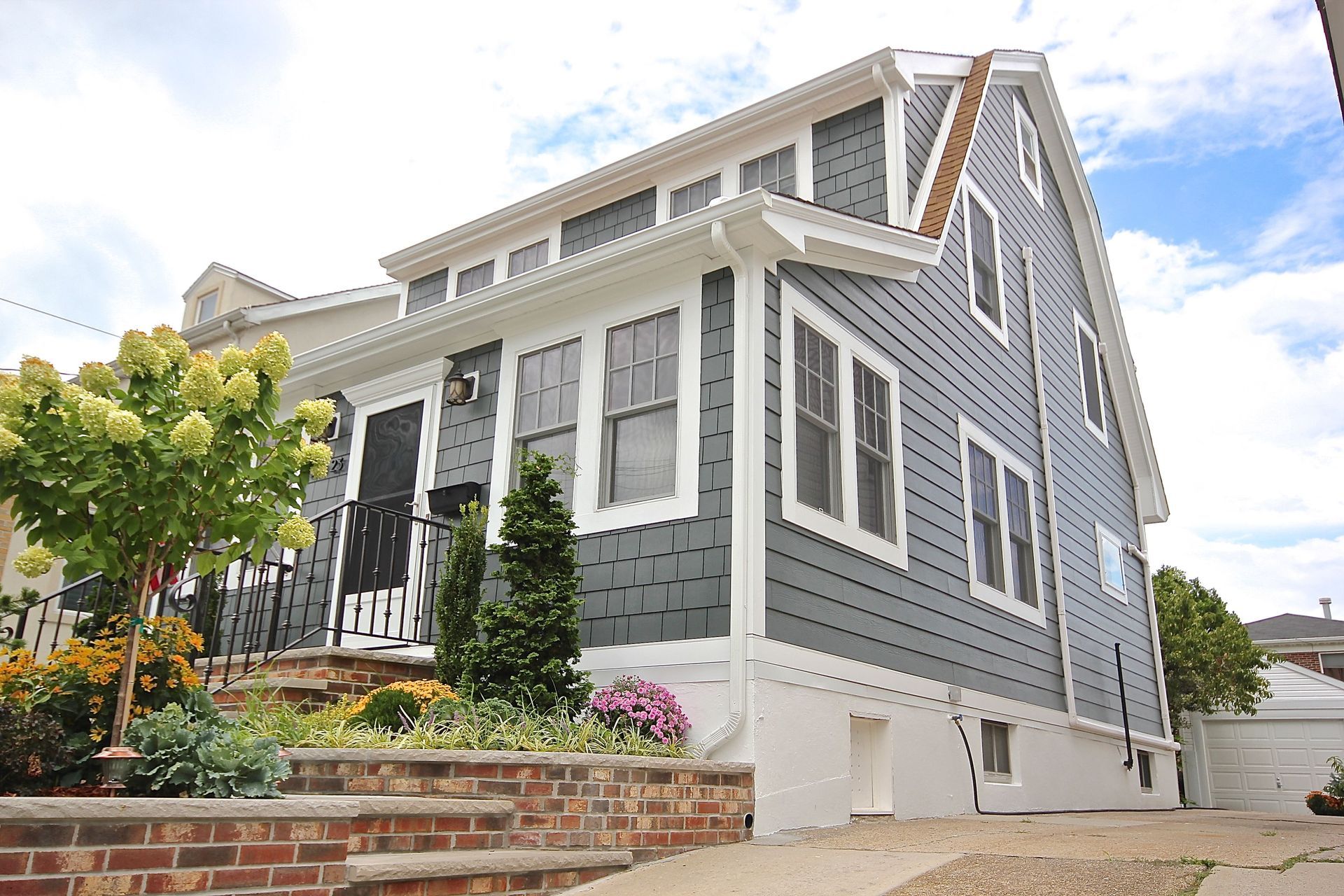 A large gray and white house with a lot of windows