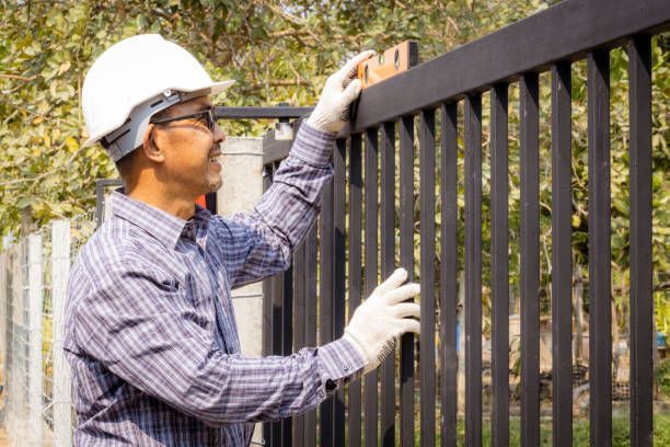 Close-up of half a technician installing a metal door.