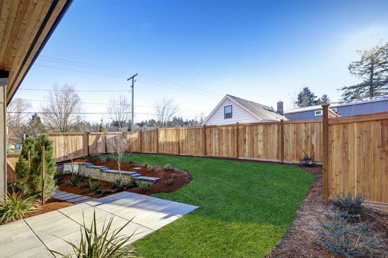 How to Build a Horizontal Plank Fence in a Hillside Backyard