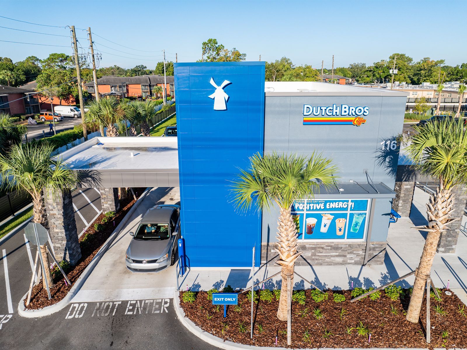 An aerial view of a burger king restaurant with a car parked in front of it.