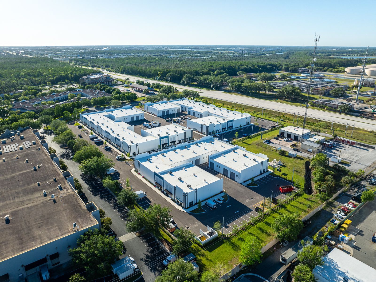 An aerial view of a large industrial area with lots of buildings and trees.