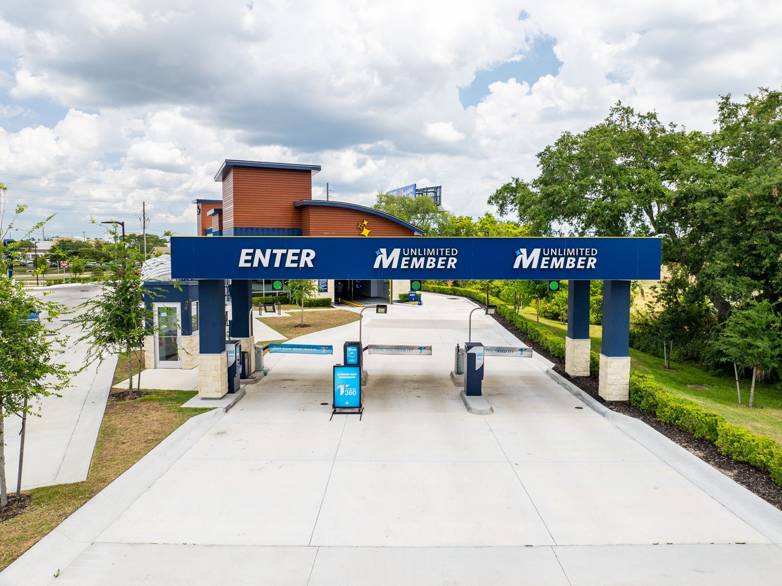 An aerial view of a car wash with a blue sign that says enter