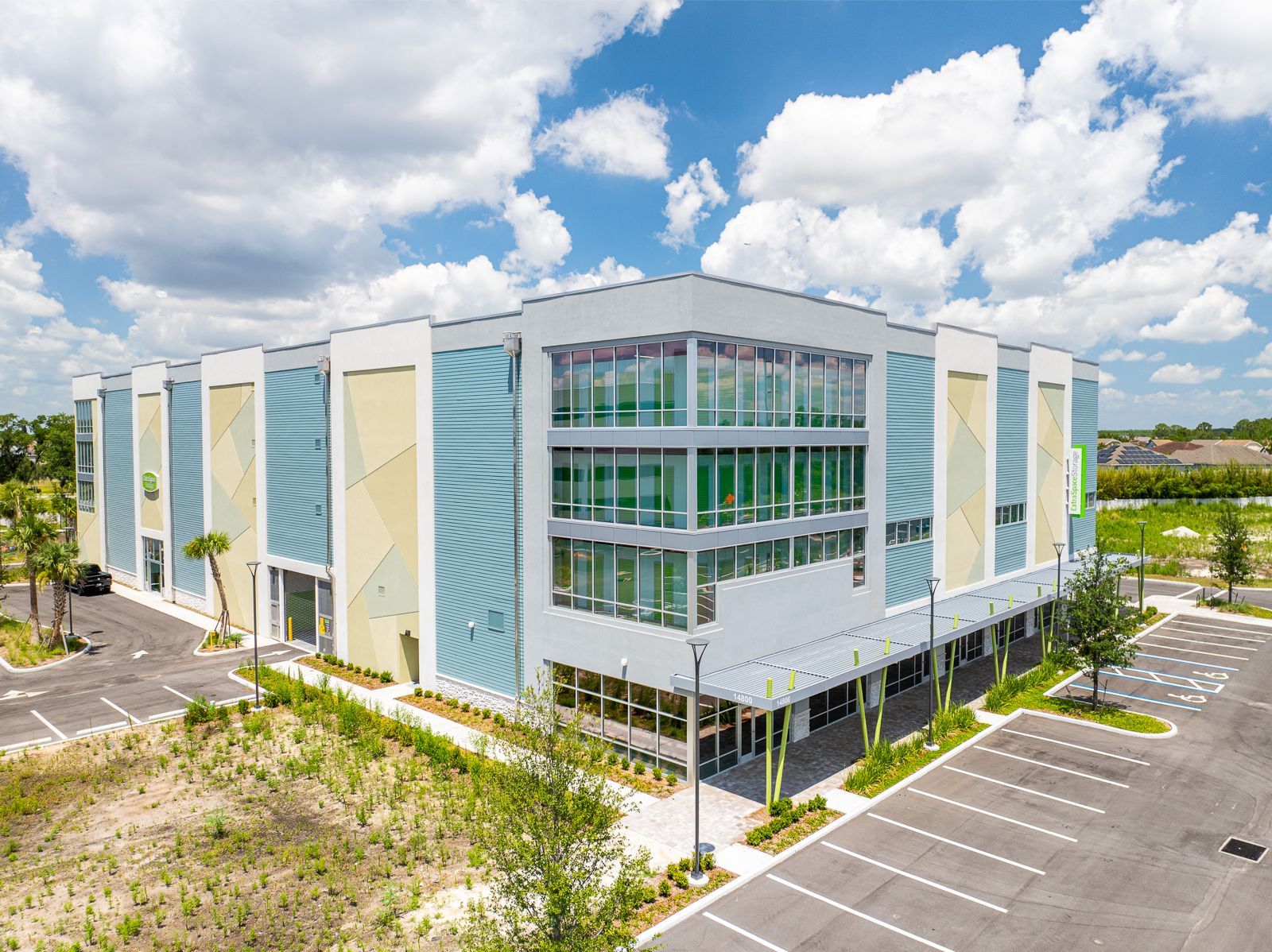 An aerial view of a large building with a parking lot in front of it.